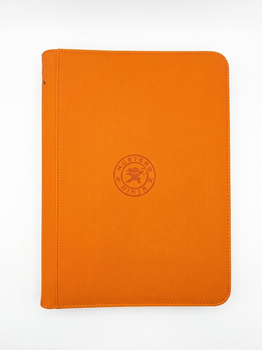 Front view of orange Mystery Ninja 360-card trading card binder featuring an embossed circular ninja emblem.

Back view of Mystery Ninja orange card binder featuring embossed ninja character artwork.

Spine view of orange Mystery Ninja trading card binder showing crossed swords and a ninja emblem.

Interior view of Mystery Ninja 360-card zippered binder showing clear double-sided 9-pocket trading card storage pages.